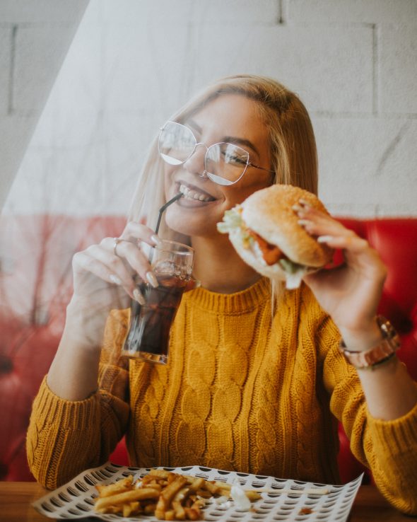 Young woman eating a burger